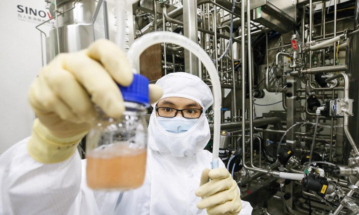A staff member collects sample to check the condition of Vero cell culture at the COVID-19 vaccine stock solution workshop in trial operation at Sinovac Life Sciences Co., Ltd. in Beijing, capital of China, July 15, 2020. (Xinhua/Zhang Yuwei)