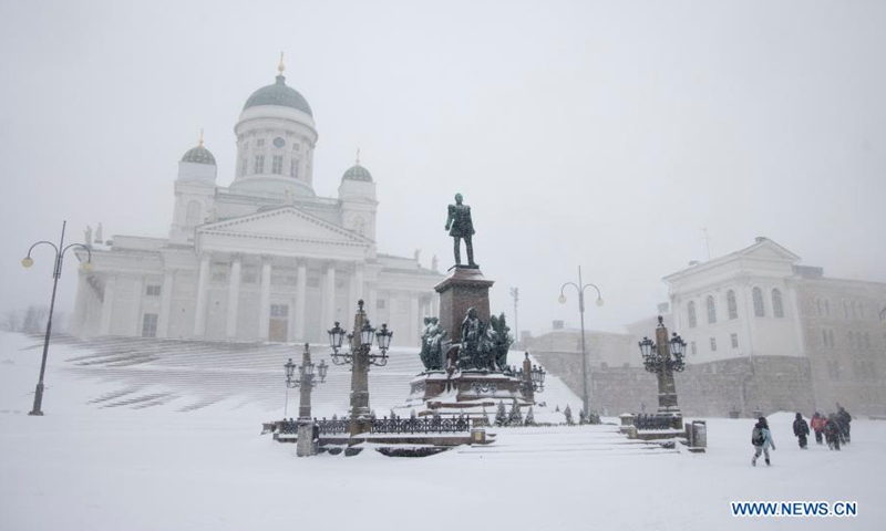 People walk past the Helsinki Cathedral in heavy snow in Helsinki, Finland, on March 9, 2021.(Photo: Xinhua)