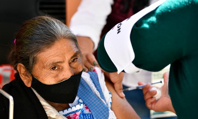 An elder woman receives a dose of the COVID-19 vaccine developed by Chinese pharmaceutical company Sinovac at an inoculation site in Acaxochitlan, State of Hidalgo, Mexico, March 9, 2021.Photo:Xinhua
