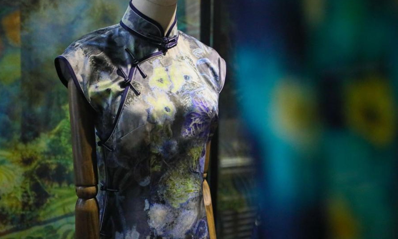 Photo taken on March 9, 2021 shows a cheongsam with dyeing technique at a research institute in Lanzhou Jiaotong University, northwest China's Gansu Province. The dyes used in this ancient printing and dyeing technique are all natural. Such technique has been listed as a provincial-level intangible cultural heritage.Photo:Xinhua