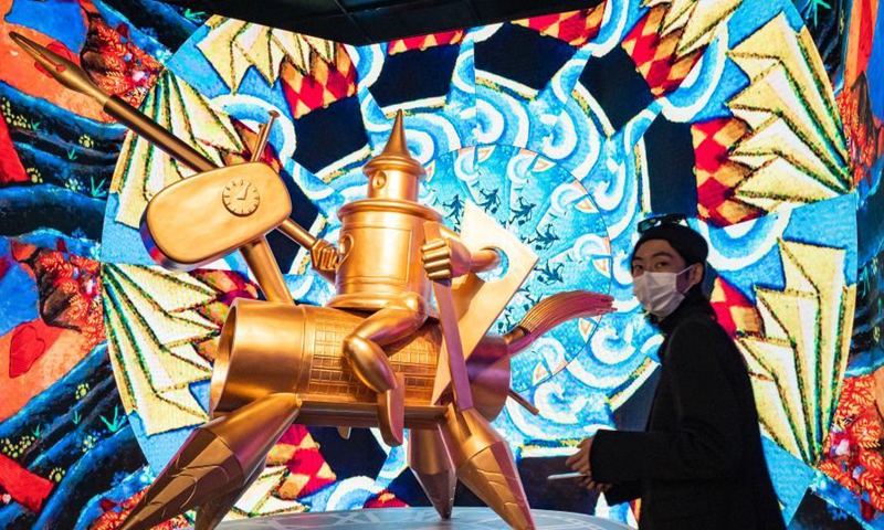 A visitor looks at a sculpture of a comic knight during an art exhibition at Guardian Art Center, Beijing, March 9, 2021.Photo:China News Service