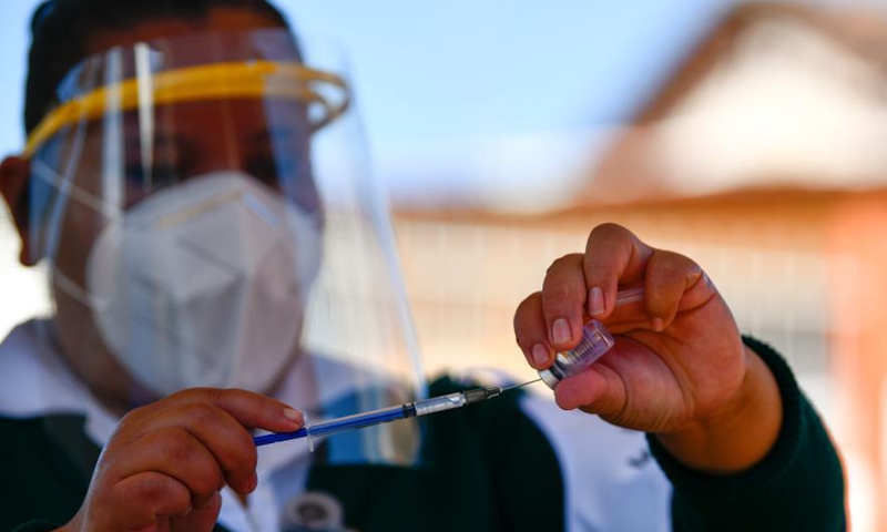 A medical worker prepares a dose of COVID-19 vaccine developed by Chinese pharmaceutical company Sinovac at an inoculation site in Acaxochitlan, State of Hidalgo, Mexico, March 9, 2021.Photo:Xinhua