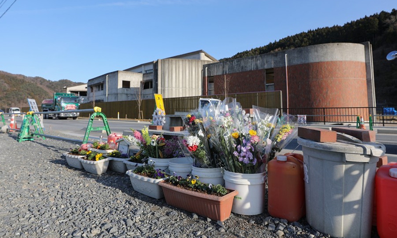 Flowers are laid in front of the ruins of the Okawa Elementary School in Ishinomaki, Japan, March 9, 2021.(Photo: Xinhua)