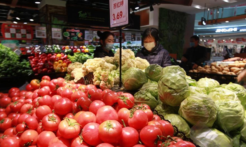 People select food at a supermarket in Pingyi County, Linyi, east China's Shandong Province, March 10, 2021.Photo:Xinhua