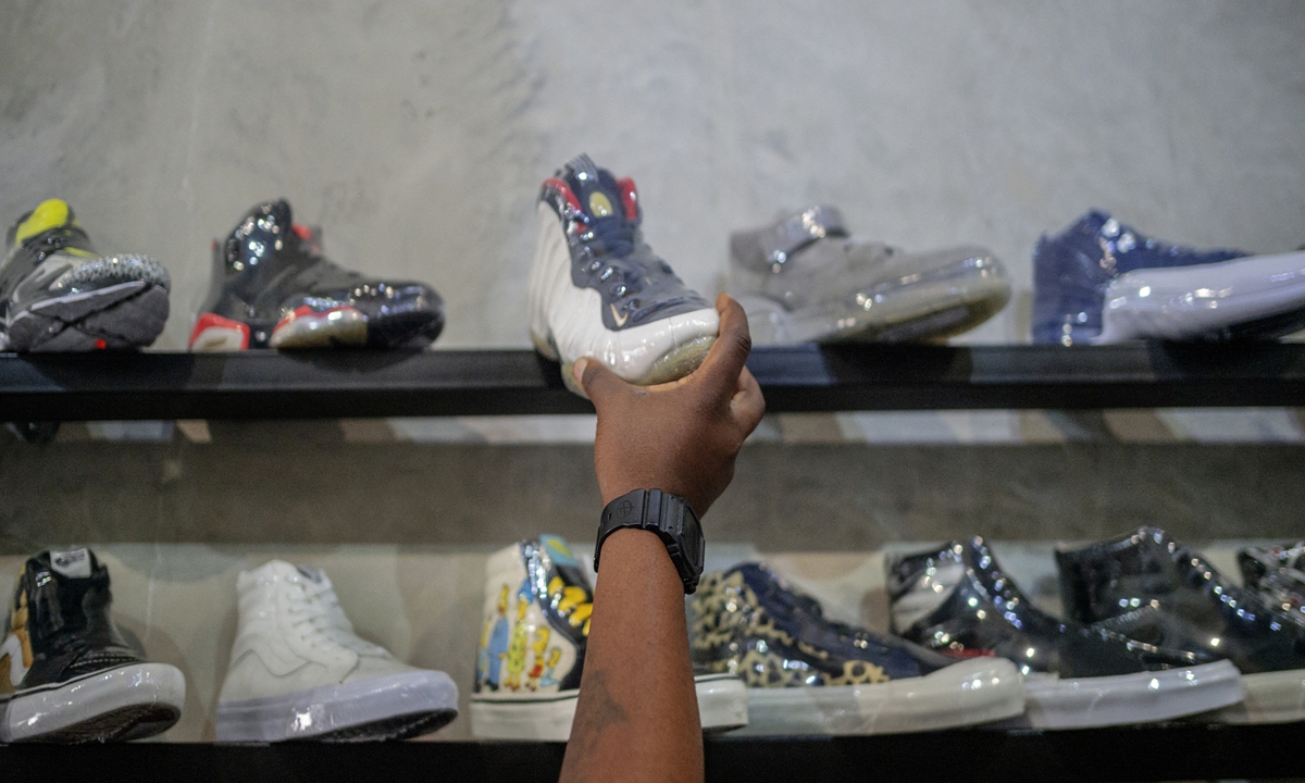 A sneaker is taken off a shelf of Court Order vintage sneakers reseller shop in Rosebank, Johannesburg, on February 18. Photo: AFP