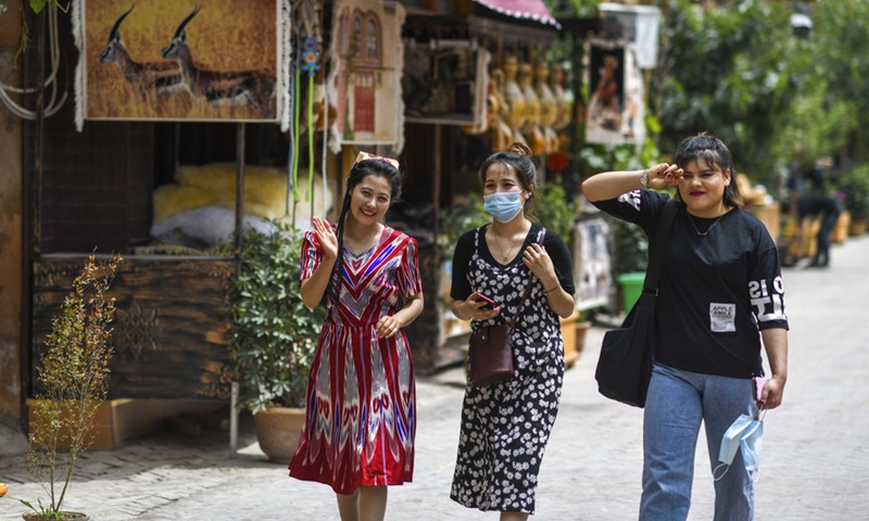 Local residents walk in a street at a scenic spot in the ancient city of Kashgar, northwest China's Xinjiang Uygur Autonomous Region, May 16, 2020.Photo:Xinhua