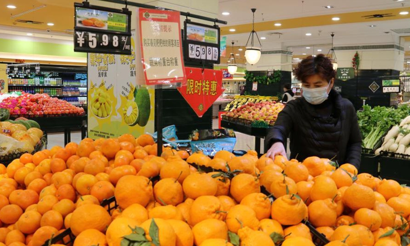 People select food at a supermarket in Nanjing, east China's Jiangsu Province, March 10, 2021.Photo:Xinhua