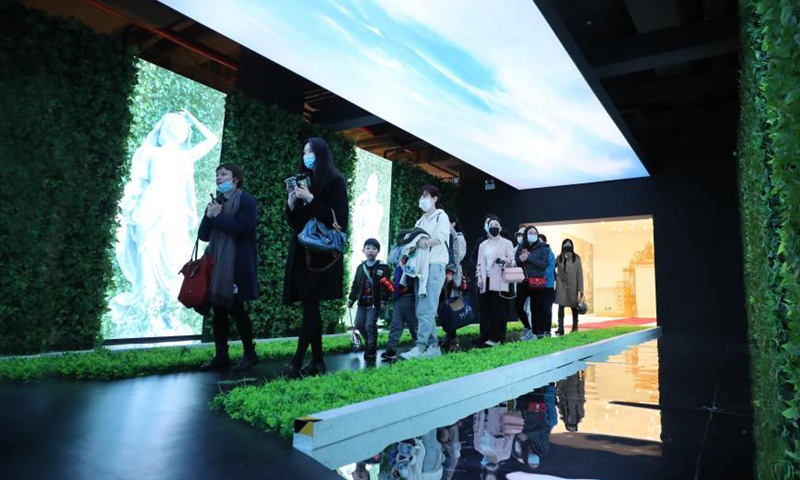 Visitors walk in an exhibition hall themed on the garden of the Versailles palace during an exhibition in Shanghai, east China, March 12, 2021. A China itinerant exhibition of Versailles palace is held at Xintiandi commercial complex in Shanghai, during which digital technologies and interactive activities offer people the unique experience of visiting the palace. Photo:Xinhua