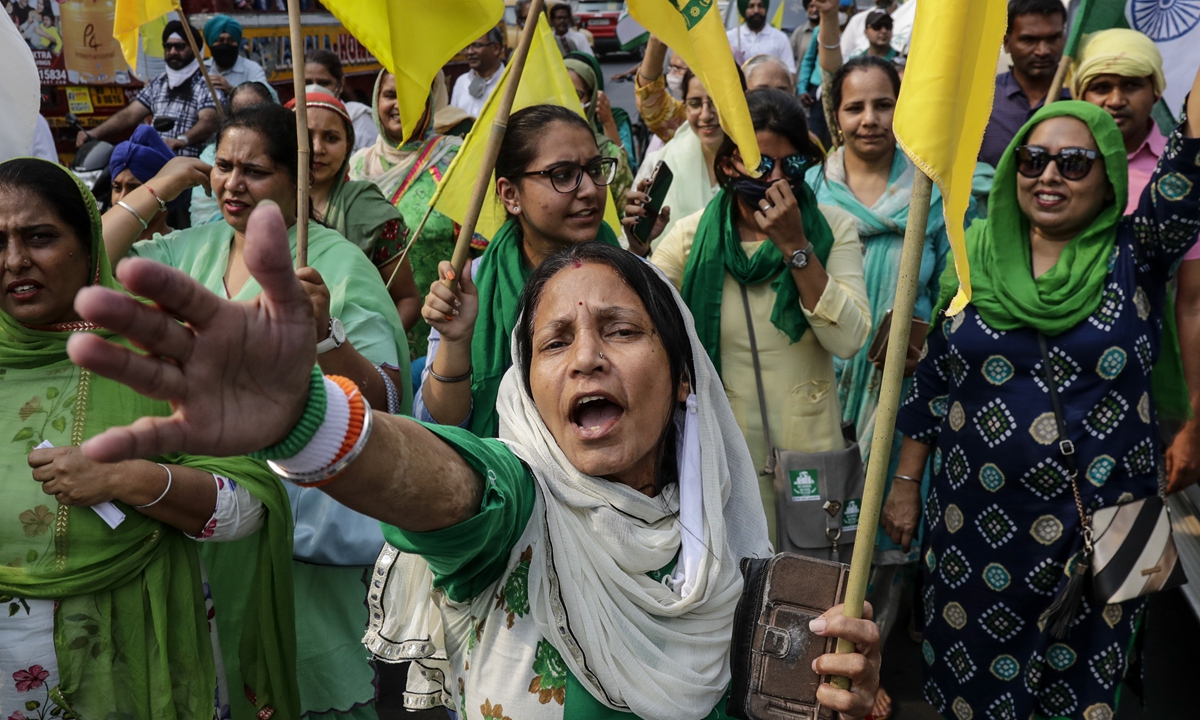 Women supporters of Samyukt Kisan Morcha, a farmer's platform, chant at a rally demanding a roll back of new agriculture laws in Kolkata, India on Friday. Photo: AP