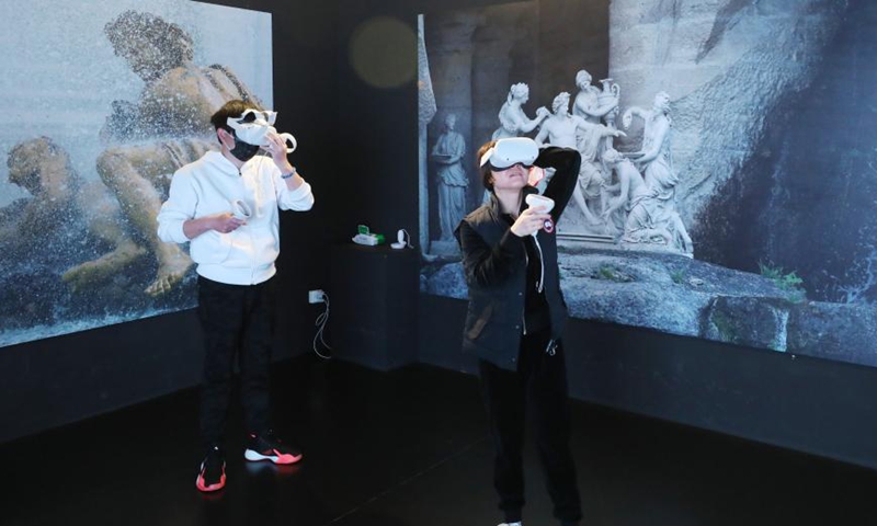 People use VR glasses to visit the Versailles palace during an exhibition in Shanghai, east China, March 12, 2021. A China itinerant exhibition of Versailles palace is held at Xintiandi commercial complex in Shanghai, during which digital technologies and interactive activities offer people the unique experience of visiting the palace. Photo:Xinhua