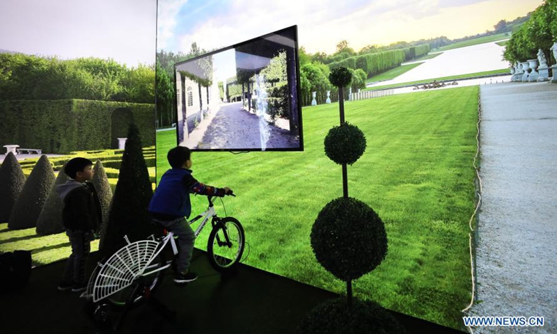 A child experiences a game of riding in the Versailles palace during an exhibition in Shanghai, east China, March 12, 2021. A China itinerant exhibition of Versailles palace is held at Xintiandi commercial complex in Shanghai, during which digital technologies and interactive activities offer people the unique experience of visiting the palace. Photo:Xinhua