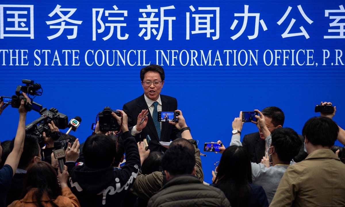 Zhang Xiaoming (center), deputy director of the Hong Kong and Macao Affairs Office of the State Council, gestures in front of journalists at the end of a State Council press conference on Hong Kong's electoral reform in Beijing on Friday. Photo: VCG 