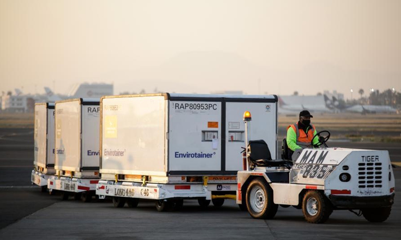 A staff member carries containers of the COVID-19 vaccine from the Chinese pharmaceutical company Sinovac at the Mexico City's international airport in Mexico, March 13, 2021. The third shipment of the COVID-19 vaccine from the Chinese pharmaceutical company Sinovac arrived Saturday at the Mexico City's international airport.Photo:Xinhua