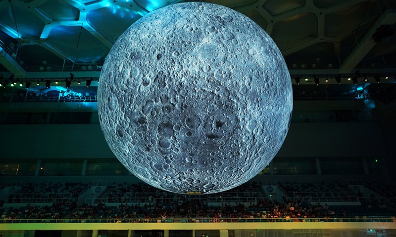 File photo showa visitors view a huge moon model during an exhibition on moon held at the National Aquatic Center or Water Cube in Beijing, capital of China, July 8, 2018.(Photo: Xinhua)