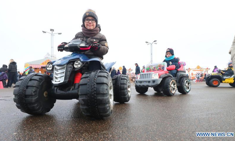 Kids ride electric toy vehicles during the Maslenitsa festival celebrations in Minsk, Belarus, March 13, 2021. Maslenitsa is a religious holiday to celebrate the beginning of spring.(Photo: Xinhua)