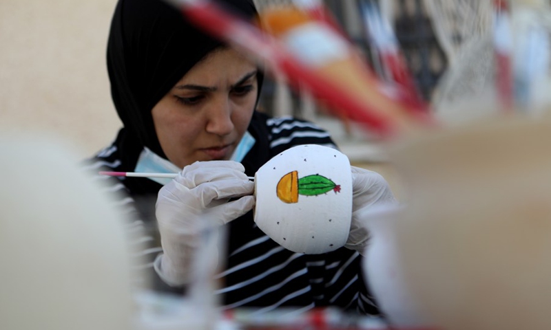 Lubna Al-Fakyat (L) and her sister Amal (R) display their work at their home in the West Bank city of Hebron on March 13, 2021.(Photo: Xinhua)