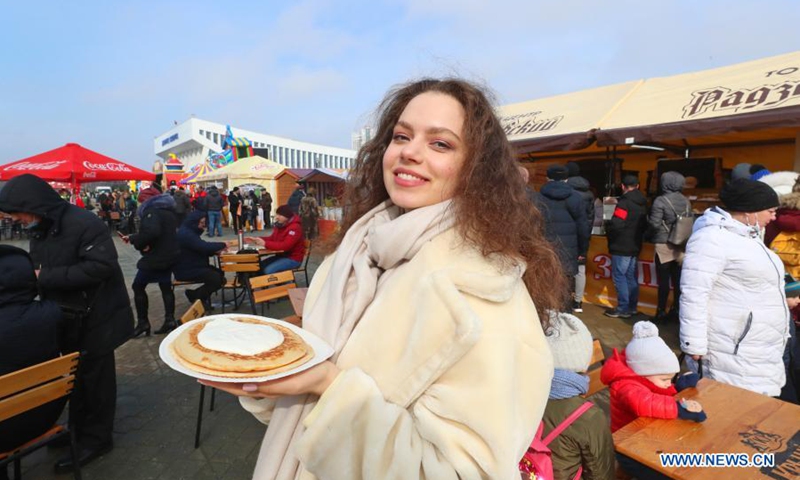 A woman shows festival pancakes at the Maslenitsa festival celebrations in Minsk, Belarus, March 13, 2021. Maslenitsa is a religious holiday to celebrate the beginning of spring.(Photo: Xinhua)