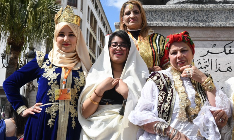 Tunisian women pose for a picture during celebration of the Tunisian National Traditional Costume Day in downtown Tunis, Tunisia, on March 14, 2021.(Photo: Xinhua)