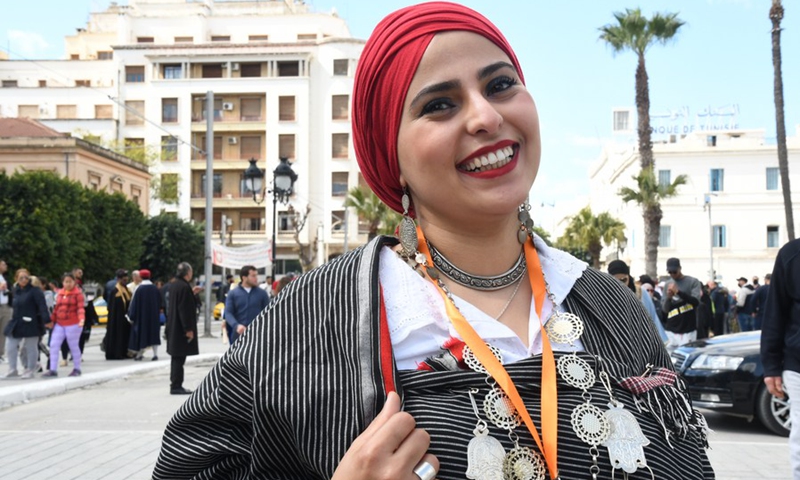 A Tunisian woman celebrates the Tunisian National Traditional Costume Day in downtown Tunis, Tunisia, on March 14, 2021. (Photo: Xinhua)