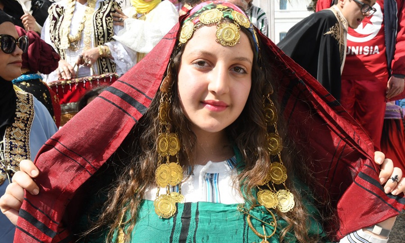 A Tunisian girl takes part in the celebration of the Tunisian National Traditional Costume Day in downtown Tunis, Tunisia, on March 14, 2021.(Photo: Xinhua)