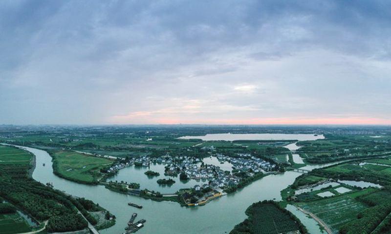 Aerial panorama photo taken on Aug. 8, 2020 shows the sunrise of Jianghang Village of Zhangpu Town in Kunshan City, east China's Jiangsu Province.(Photo: Xinhua)