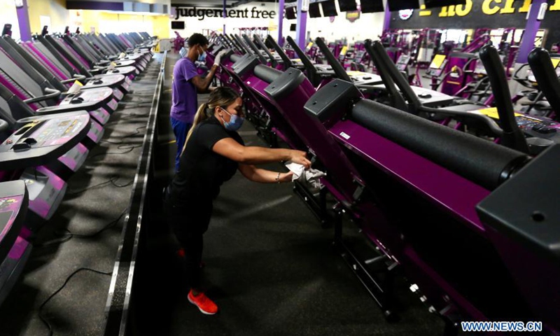 Staff members of Planet Fitness prepare for reopening to the public in Inglewood, Los Angeles County, California, the United States, March 15, 2021. Gyms, restaurants, movie theaters and museums in Los Angeles County are allowed to resume limited indoor operations on Monday after the most populous county in the country loosened restrictions against COVID-19. Photo:Xinhua