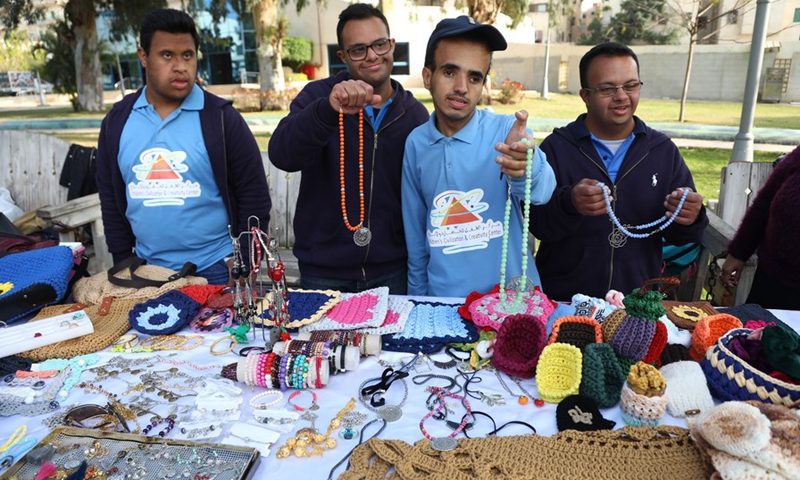 Children with Down syndrome display handmade items during an exhibition in Cairo, Egypt, on March 12, 2021. (Photo: Xinhua)