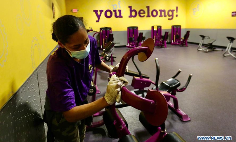 A staff member of Planet Fitness prepares for reopening to the public in Inglewood, Los Angeles County, California, the United States, March 15, 2021. Gyms, restaurants, movie theaters and museums in Los Angeles County are allowed to resume limited indoor operations on Monday after the most populous county in the country loosened restrictions against COVID-19. Photo:Xinhua