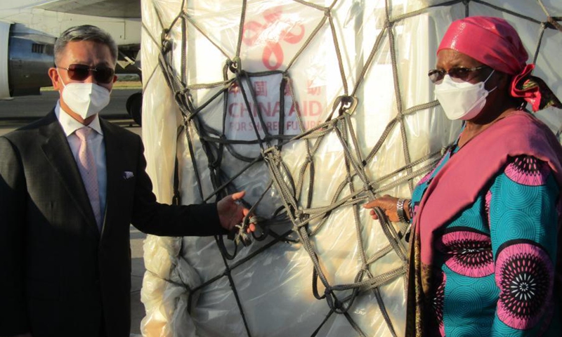 Namibian Deputy Prime Minister and Minister of International Relations and Cooperation Netumbo Nandi-Ndaitwah (R) and Chinese Ambassador to Namibia Zhang Yiming pose for photos with COVID-19 vaccines from China at the Hosea Kutako International Airport in Namibia's capital Windhoek on March 16, 2021.Photo:Xinhua