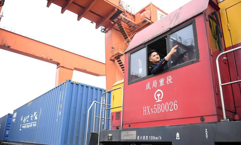 A driver signals before a Yuxin'ou (Chongqing-Xinjiang-Europe) China-Europe freight train leaves the Tuanjie Village Station of southwest China's Chongqing Municipality, March 19, 2021. Photo: Xinhua
