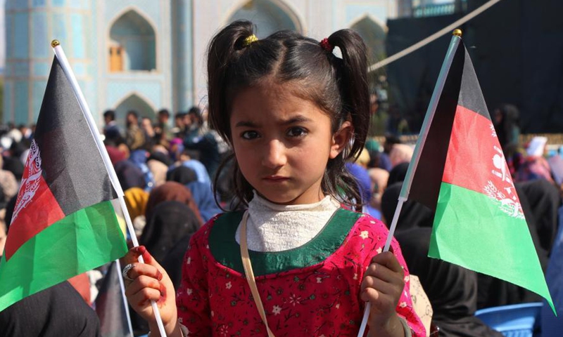 An Afghan girl attends a gathering at Hazrat-e-Ali Shrine, or the Blue Mosque, to celebrate the annual Nowruz festival in Mazar-i-Sharif, capital of Balkh province, Afghanistan, March 21, 2021. March 21 is the first day of Nowruz and the start of the year 1400 in Persian calendar. War-weary Afghans marked it with praying for peace as in many mosques, worshippers prayed for ending the war and returning lasting peace in their war-torn country. (Photo by Kawa Basharat/Xinhua)