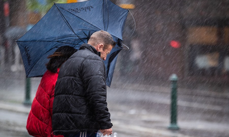People walk in the rain in Sydney, Australia, March 20, 2021.(Photo: Xinhua)