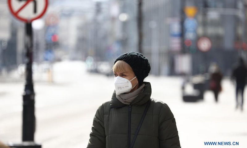 A woman wearing a face mask walks on a street in central Warsaw, Poland, on March 20, 2021. The government of Poland announced a new nationwide partial lockdown on Friday after the cumulative number of COVID-19 cases since the start of the pandemic exceeded two million in the country. (Photo: Xinhua)