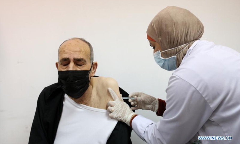A man receives a dose of COVID-19 vaccine during a vaccination campaign at the health ministry office in the West Bank city of Nablus, March 21, 2021.(Photo: Xinhua)