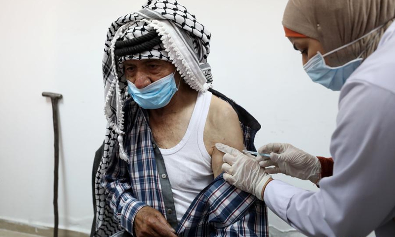 A man receives a dose of COVID-19 vaccine during a vaccination campaign at the health ministry office in the West Bank city of Nablus, March 21, 2021.(Photo: Xinhua)