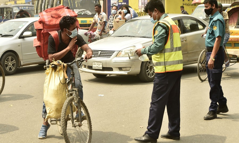 Law enforcers ask people to abide by the COVID-19 hygiene guidelines including wearing masks in Dhaka, Bangladesh on March 21, 2021.(Photo: Xinhua)