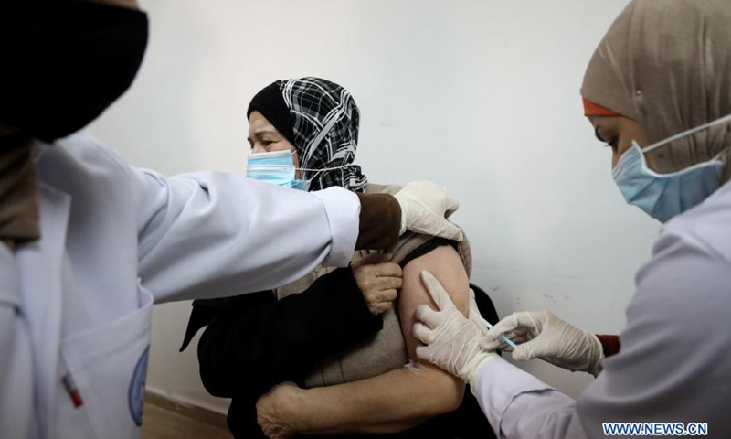 A woman receives a dose of COVID-19 vaccine during a vaccination campaign at the health ministry office in the West Bank city of Nablus, March 21, 2021.(Photo: Xinhua)
