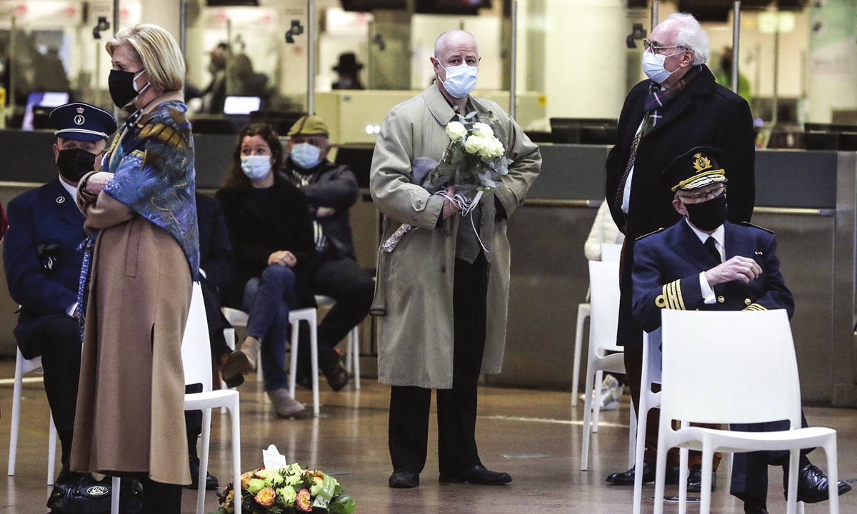 On Monday, relatives of victims of the 2016 terrorist attacks stand inside the Brussels Airport in Belgium ahead of a ceremony in Zaventem to commemorate the fifth anniversary of the attacks. On March 22, 2016, 32 people were killed and 324 were injured in suicide bombings at the airport and in the Brussels subway. Photo: AFP