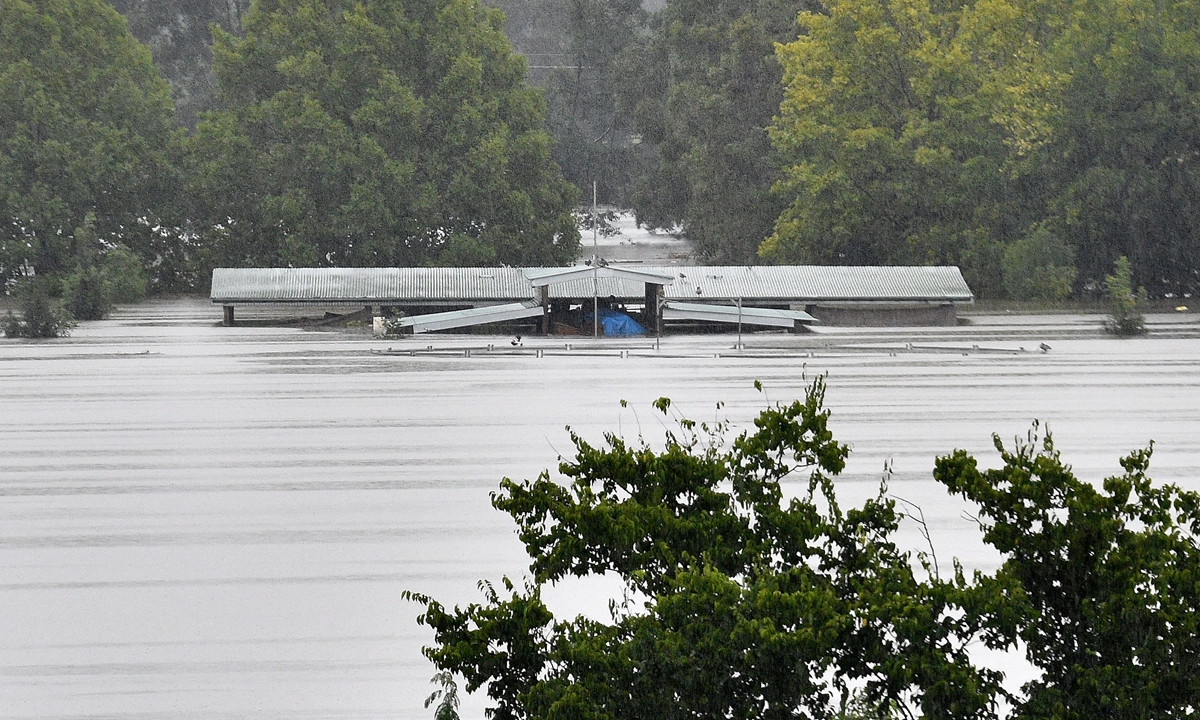 An inundated barn is seen in the floodwaters in the residential area of Richmond suburb on March 22, 2021, as Sydney braced for its worst flooding in decades after record rainfall caused its largest dam to overflow and as deluges prompted mandatory mass evacuation orders along Australia's east coast. Photo: VCG