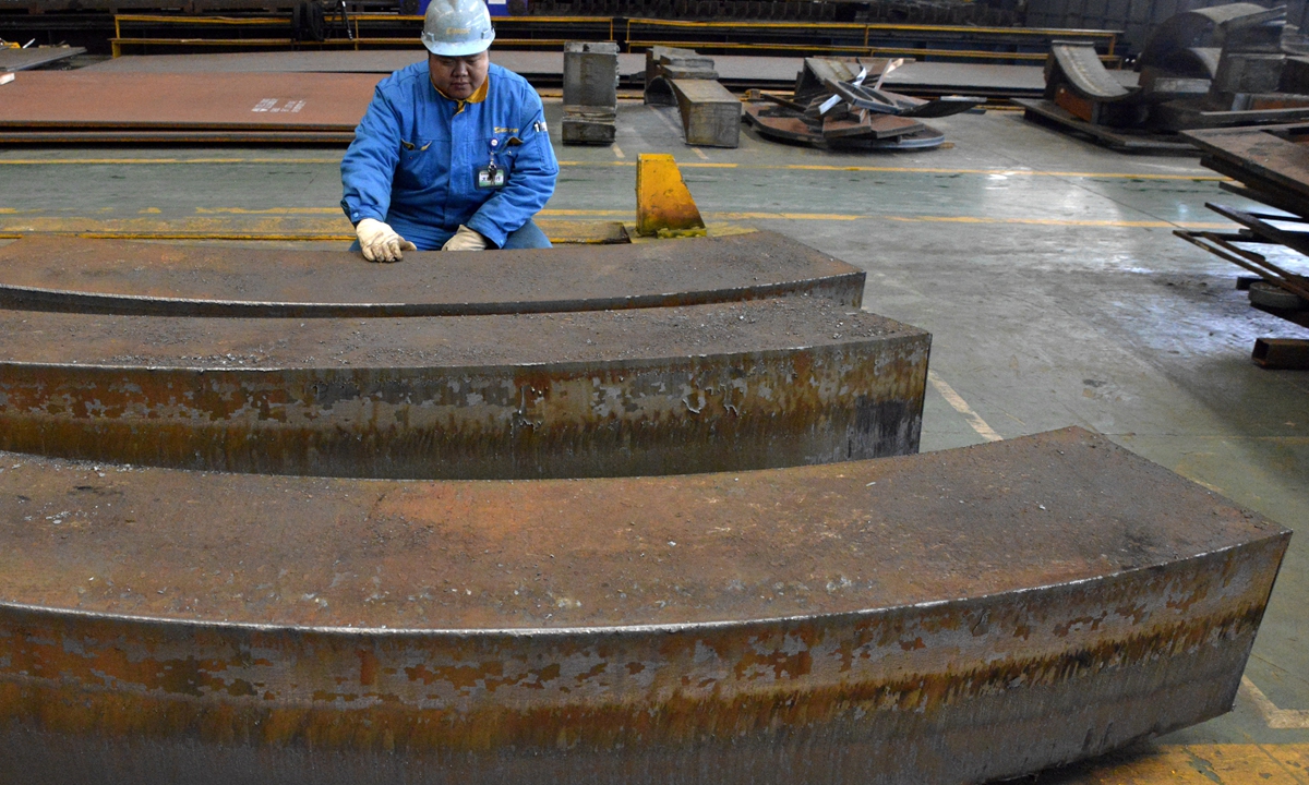 A worker checks the quality of steel plates at a factory in Taizhou, East China's Jiangsu Province on Monday. Data from the National Bureau of Statistics showed that in the first two months of 2021, China's total value added of industrial enterprises above designated size grew by 35.1 percent year-on-year. Photo: cnsphoto