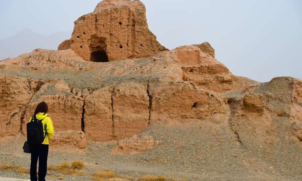 A tourist visits the ruins of the Subax buddhist temple in Kuqa City of northwest China's Xinjiang Uygur Autonomous Region, on March 22, 2021. The Subax buddhist temple, intially built in the 3rd century A.D., was once an influential temple in the ancient Qiuci State. (Xinhua/Hou Zhaokang)
