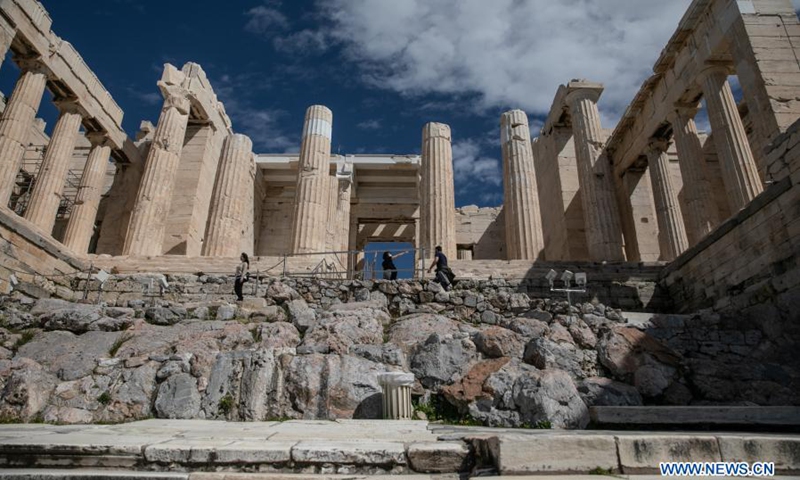 People visit the archeological site of Acropolis in Athens, Greece, on March 22, 2021. On Monday, open-air archeological sites, including the Acropolis hill in Athens, reopened for the first time since the start of the lockdown. Only a small group of visitors is allowed to visit and the use of protective face masks is obligatory.(Photo: Xinhua)