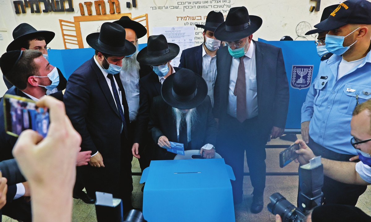 Israel's Rabbi Yerachmiel Gershon Edelstein (center) casts his vote at a polling station on Tuesday in the mostly Jewish ultra-Orthodox city of Bnei Brak. This is the Jewish state's fourth national election in two years. Voting started at 7 am local time (5:00 GMT) Tuesday in 13,685 polling stations across the country, which is due to end at 10 pm (20:00 GMT). Photo: AFP