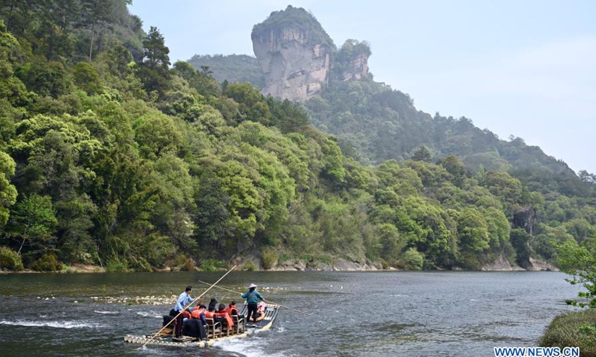 Tourists enjoy the scenery on bamboo rafts in Wuyishan National Park, southeast China's Fujian Province, March 22, 2021. Wuyi Mountain has a comprehensive forest ecosystem representative of the mid-subtropical zone. It boasts diverse groups of plants due to its varying altitudes. Wuyishan National Park was established in 2016. (Xinhua/Jiang Kehong)