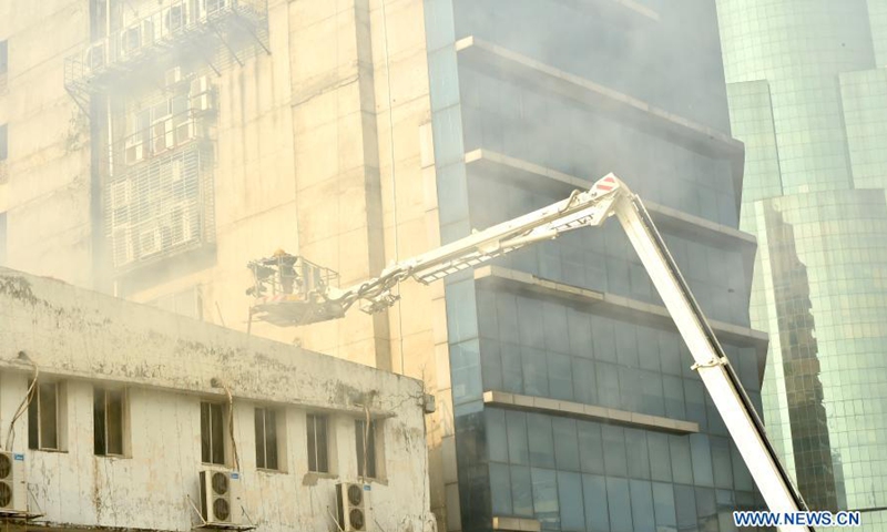 Firefighters spray water to extinguish a fire in a high-rise building in the Motijheel commercial area in Dhaka, Bangladesh, March 22, 2021. A fire engulfed a high-rise building here on Monday afternoon.(Photo: Xinhua)