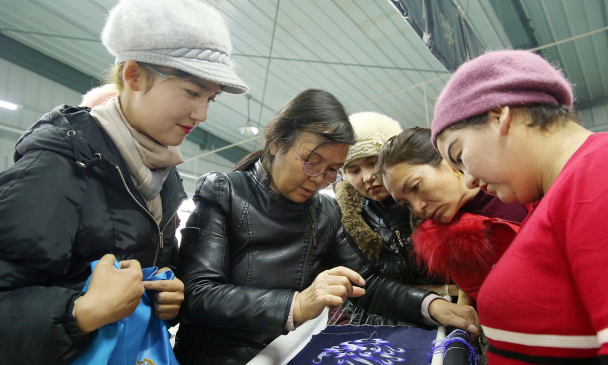 Uygur women learn embroidery at a workshop in Shule county, Xinjiang. Photo: IC