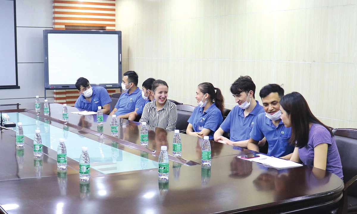Nilufer Gheyret (fourth from left) talks with ethnic minority workers from Xinjiang during her research in Guangdong factories. Photo: Courtesy of Nilufer Gheyret