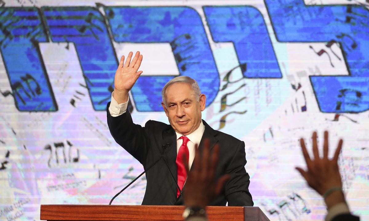 Israeli Prime Minister Benjamin Netanyahu waves to his supporters after the first exit poll results for the Israeli parliamentary elections at his Likud party's headquarters in Jerusalem, Wednesday, March. 24, 2021. Photo: VCG