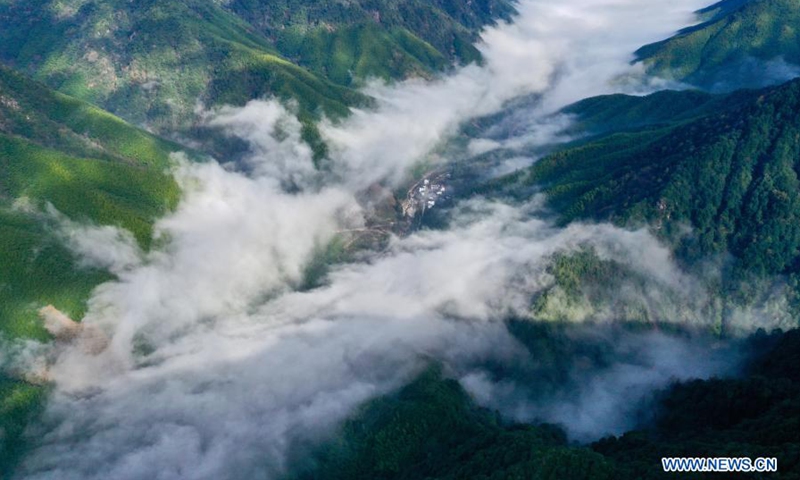 Aerial photo taken on Dec. 1, 2020 shows the mountains surrounded by cloud and mist in Wuyishan National Park, southeast China's Fujian Province. Wuyi Mountain has a comprehensive forest ecosystem representative of the mid-subtropical zone. It boasts diverse groups of plants due to its varying altitudes. Wuyishan National Park was established in 2016.(Photo: Xinhua)