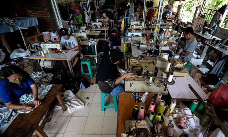 Workers sew clothes at the NCK Textile home factory at Curug village in Bogor, West Java, Indonesia, on March 23, 2021. NCK Textile produces clothes to orders from local markets, and provides job opportunities to people in its neighborhood. (Photo: Xinhua)